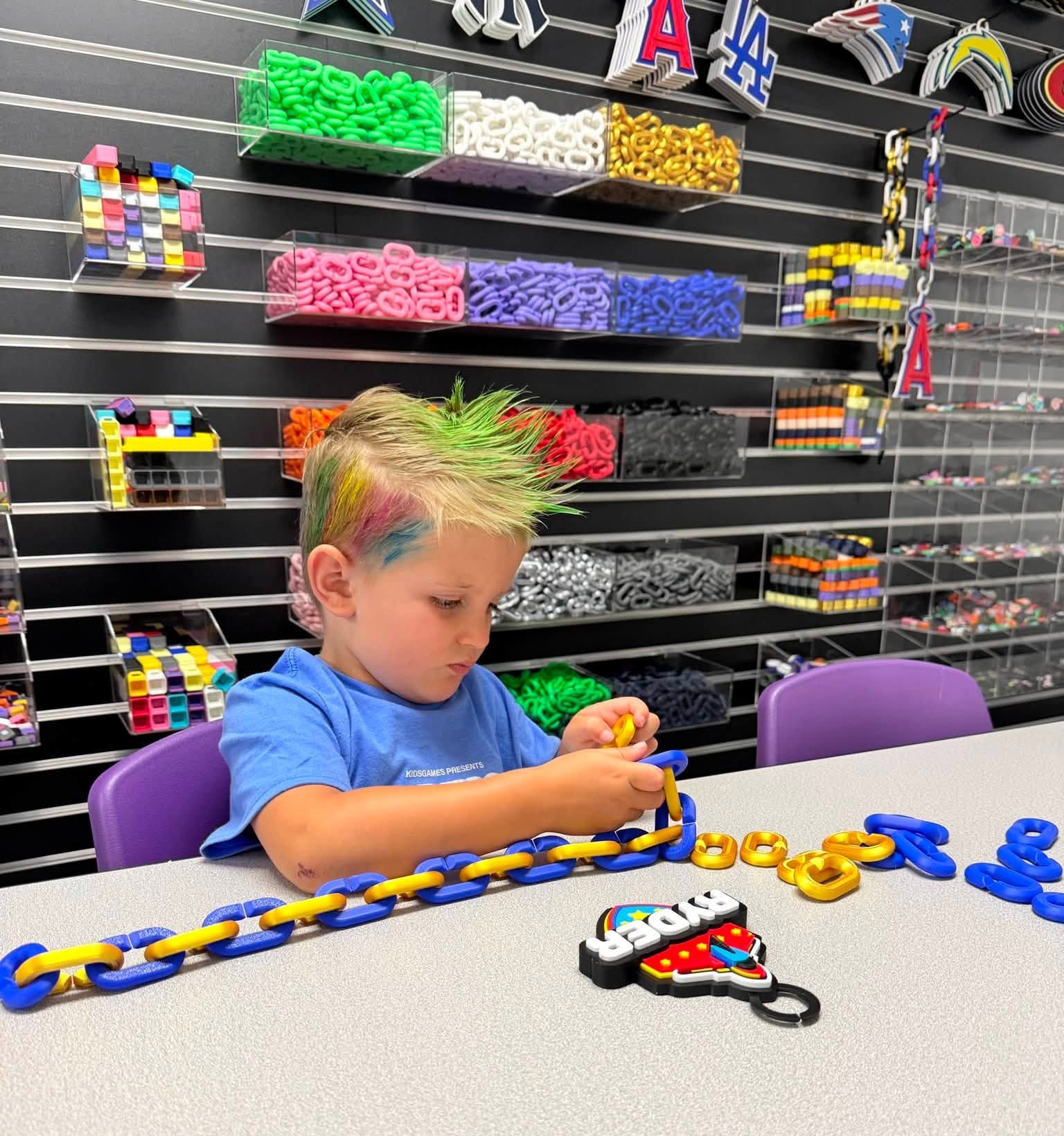 Child assembling colorful 3D printed hype chain links